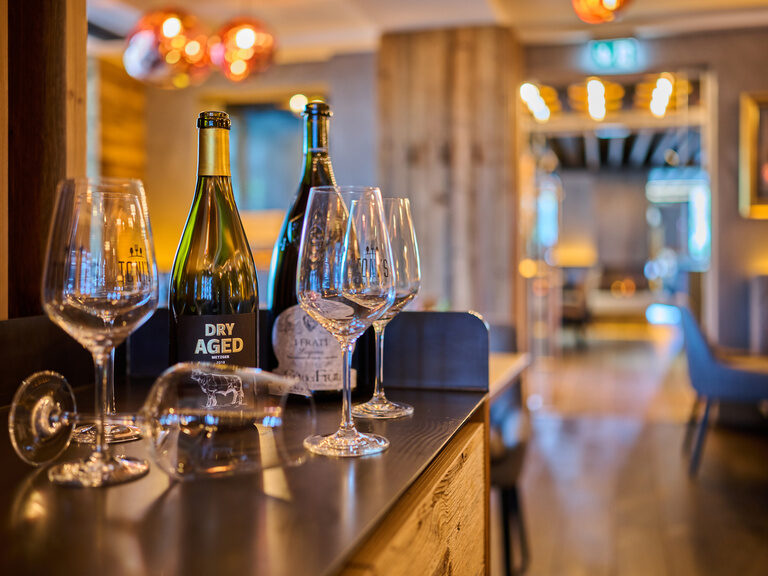 Weinflaschen und Gläser stehen für eine Dinner for Two im Toni´s Gasthaus bereit.